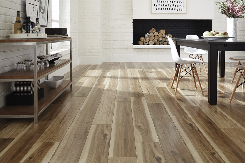 Warm wood-effect luxury vinyl tile flooring in a dining room